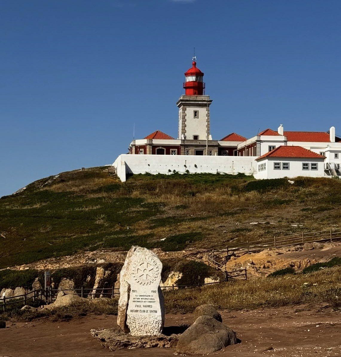 Cabo da Roca lighthouse and stone marker on a sunlit headland