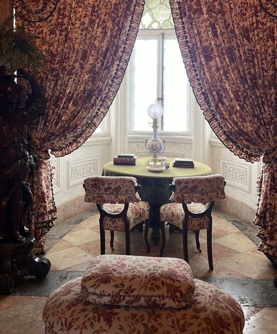 Floral curtained window nook with oil lamp inside Pena Palace rooms
