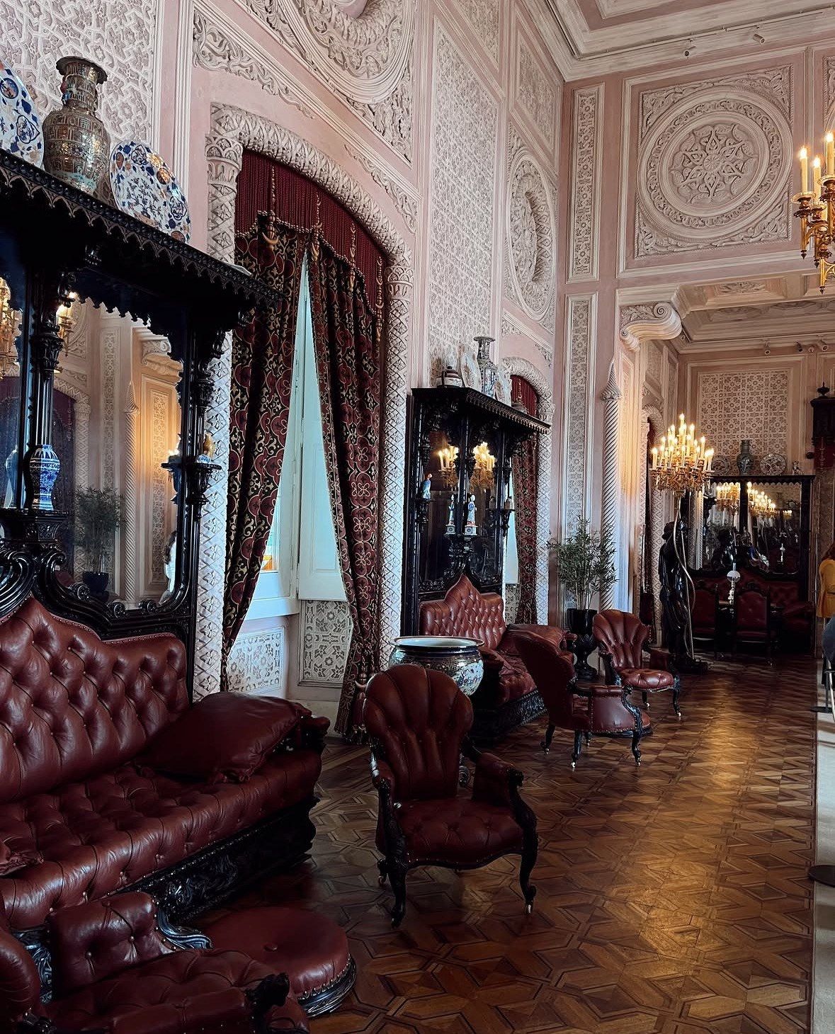 Red leather sofas and stucco walls in a Pena Palace salon