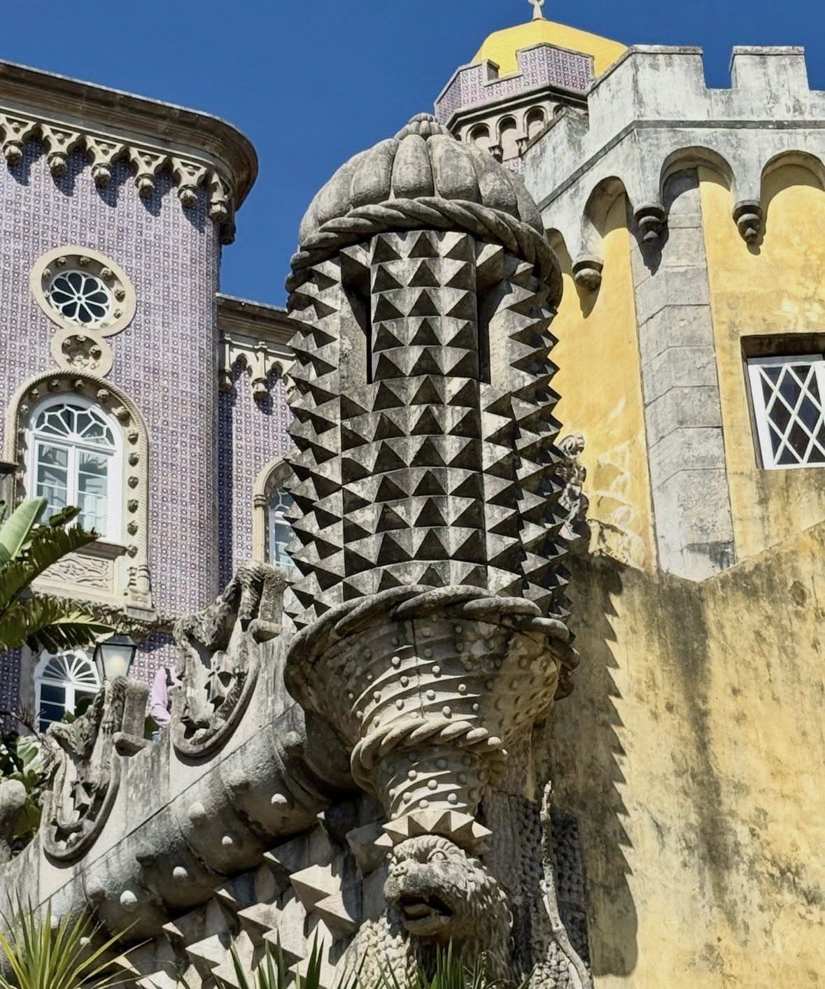 Studded stone pinnacle against violet tiles and yellow walls, Pena Palace