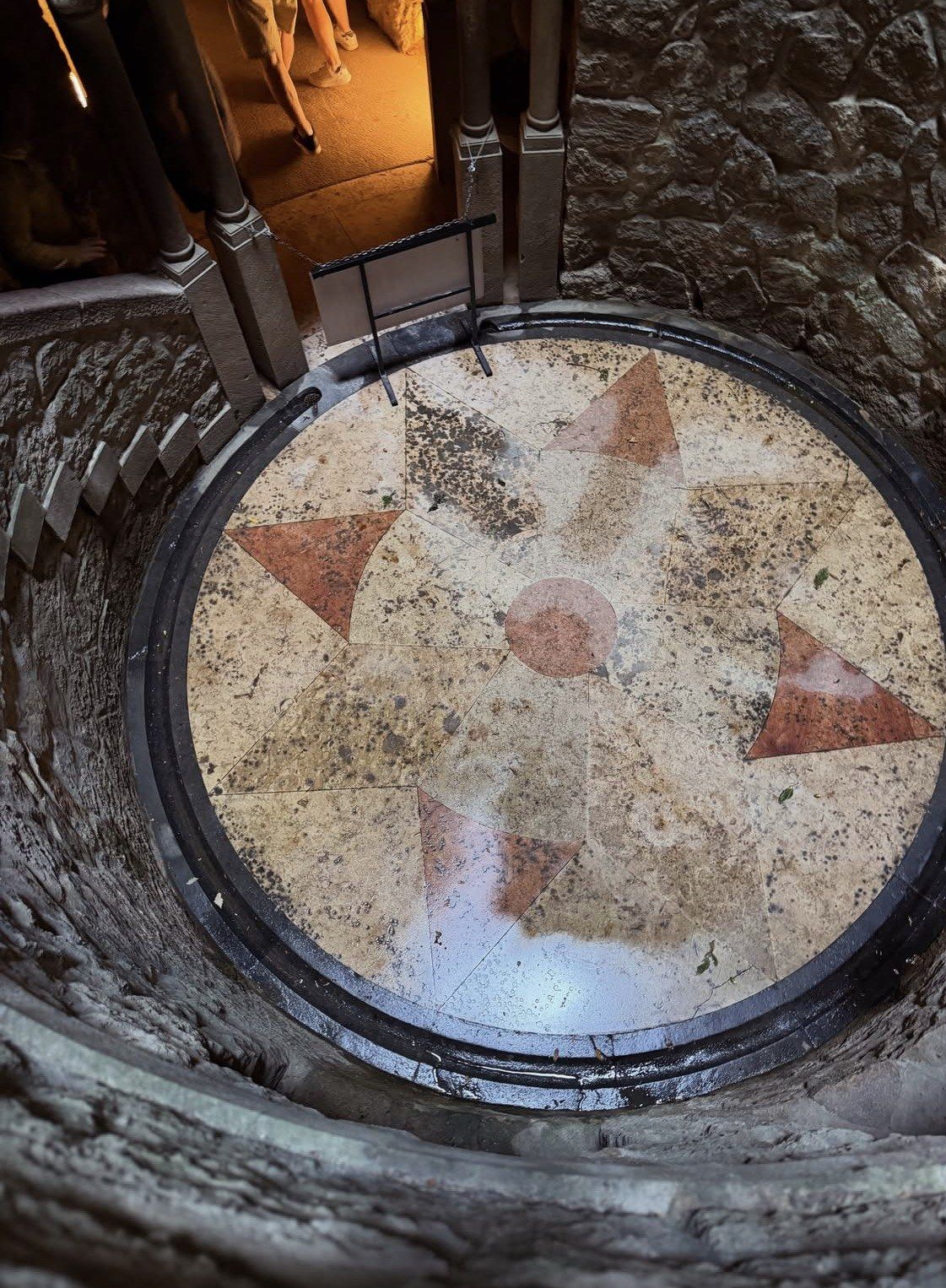 Star-patterned marble floor at the bottom of the Initiation Well