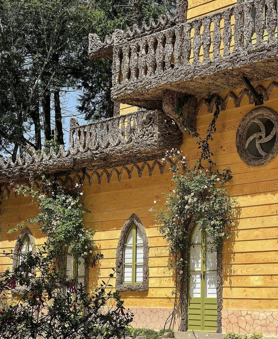 Yellow timber Chalet of the Countess of Edla with stone-crusted balconies